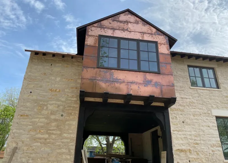 Copper metal panel facade on a stone building for Roof Repair in Salmon Creek